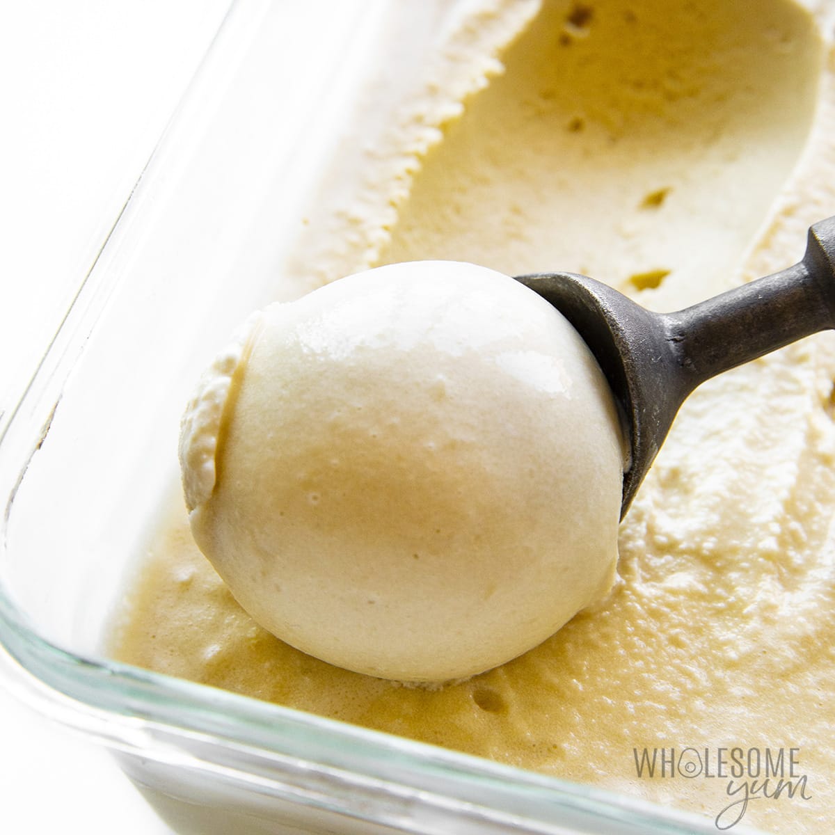 Keto coffee ice cream scooped from container with ice cream scoop