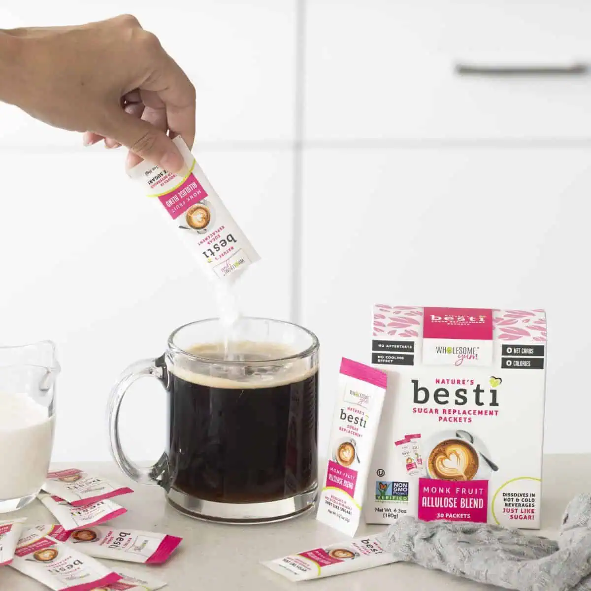 Wholesome Yum Besti sweetener packets pouring into coffee.