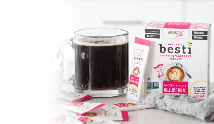 Wholesome Yum Besti Packets with coffee close up.